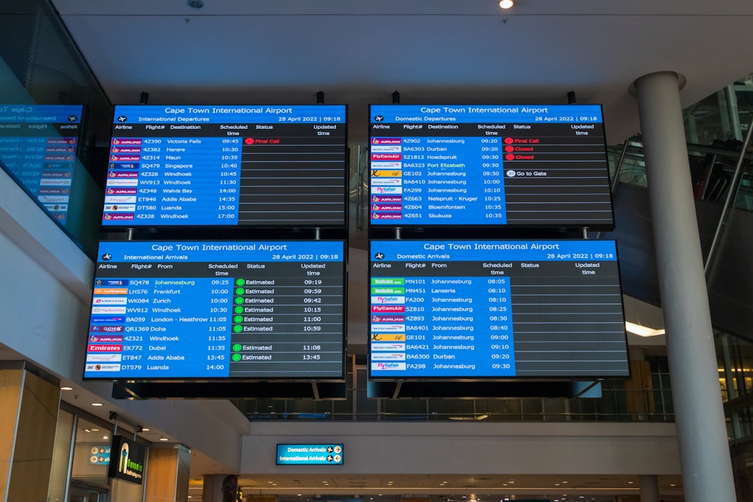a-couple-of-people-walking-through-an-airport-dub96-xyyrc