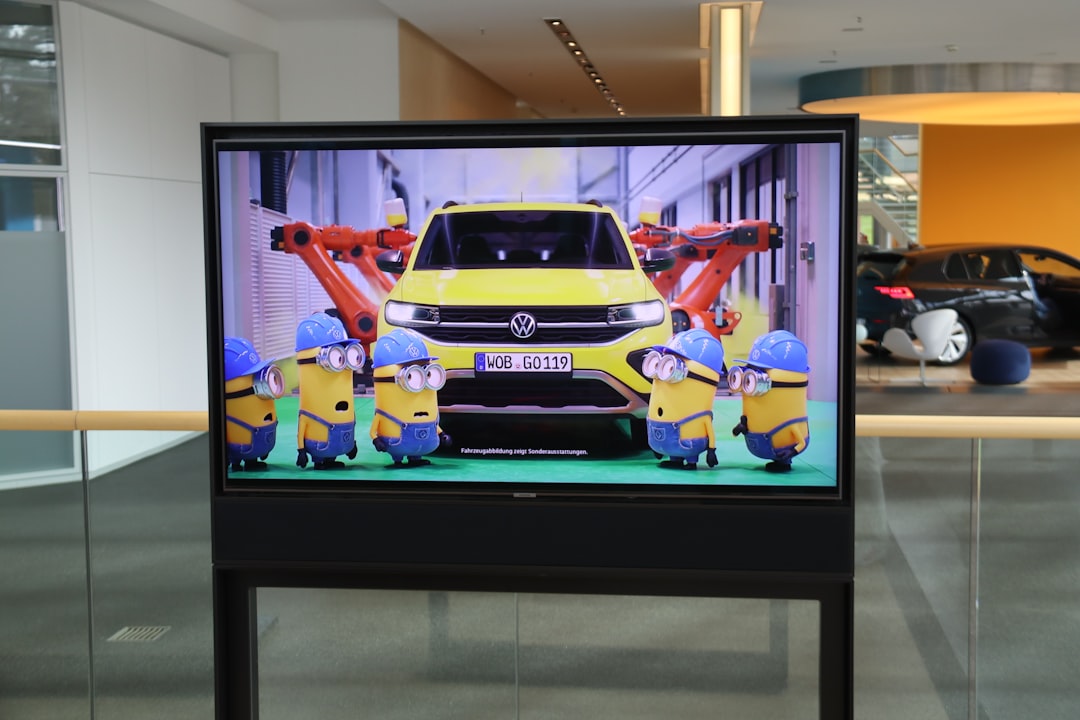 minions-surround-a-yellow-car-on-a-screen-qieq9nrsg-i